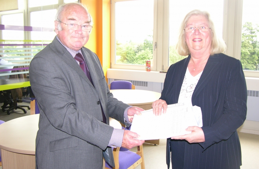 Ivan Ould CC hands Lesley Pendleton the 1,000 name petition